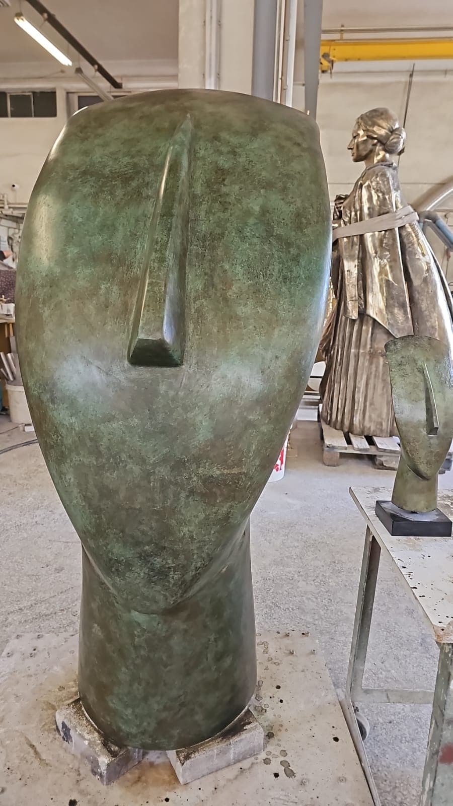 The completed form with a mottled green patina, photographed in the workshop